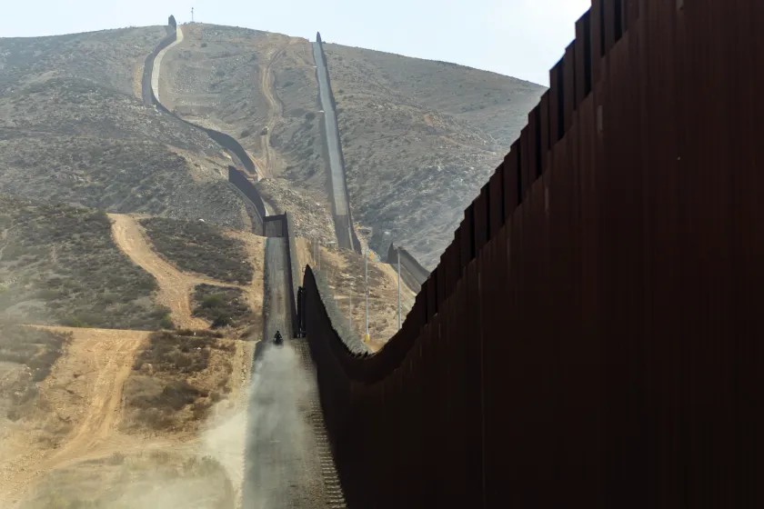 A border agent rides an ATV along the U.S.-Mexico border outside San Diego, September 2026. While the mountainous terrain makes some areas difficult to access, the area is blanketed with interconnected surveillance technology.