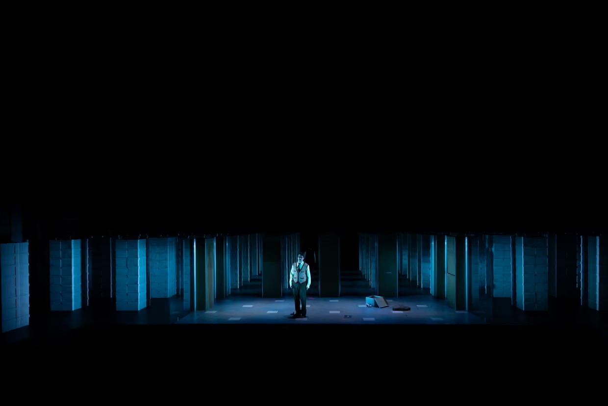 ‘The set, with its seemingly endless rows of white file boxes and spinning wheels of machinery, evokes the maddening prison of Josef K’s work environment.’ Photograph: Pia Johnson