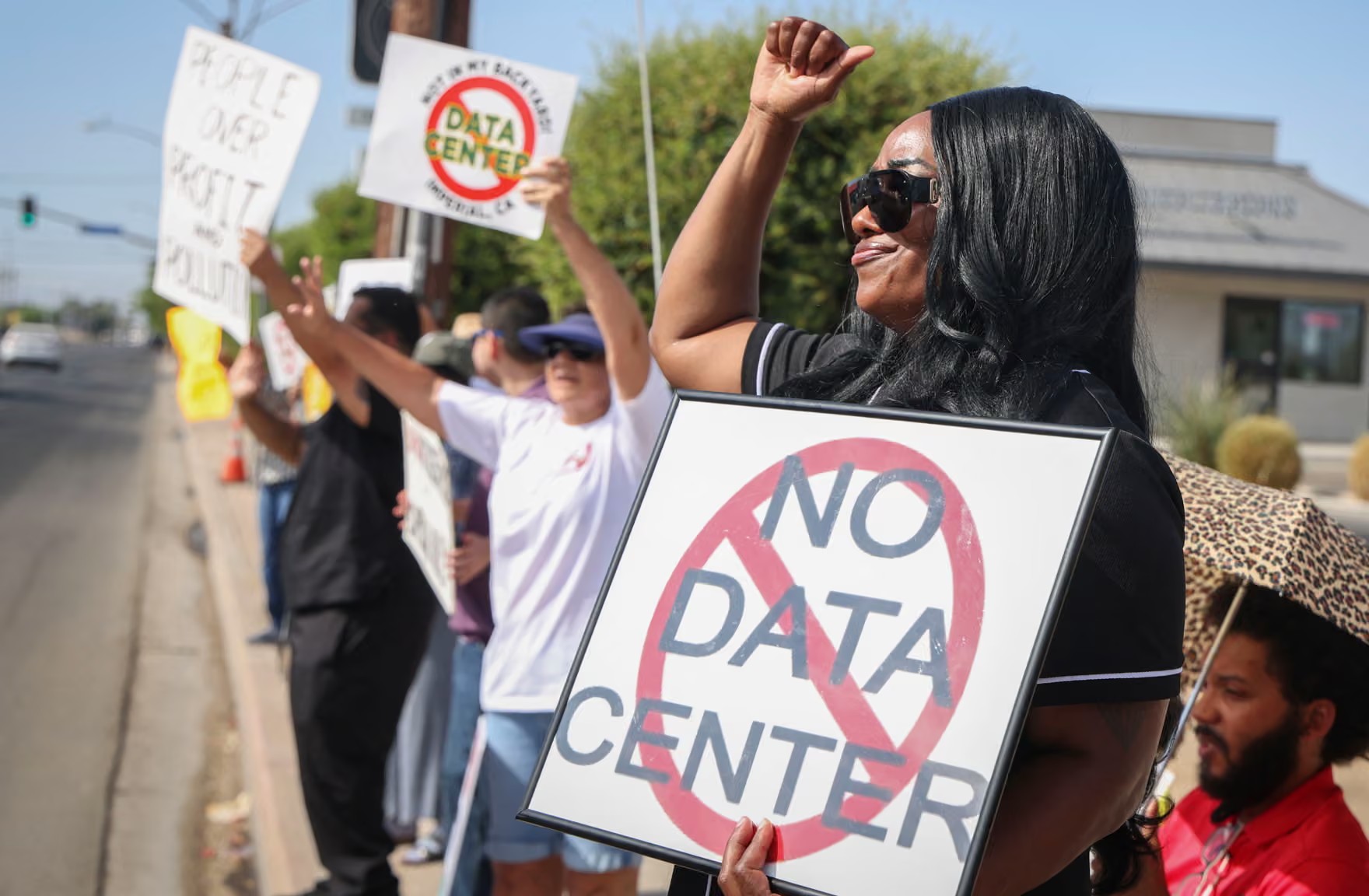 Demonstrators wave signs during a nationwide protest against AI datacenter expansion in Imperial. Photograph: Sandy Huffaker/AFP/Getty Images