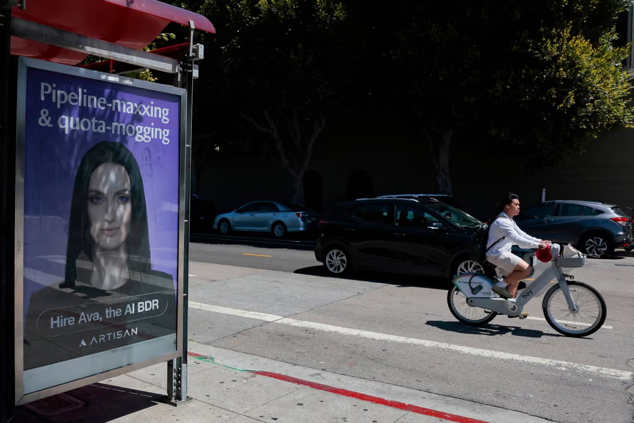 A person bikes past an AI sales agent advertisement in San Francisco, California. Photograph: Heather Diehl/Getty Images