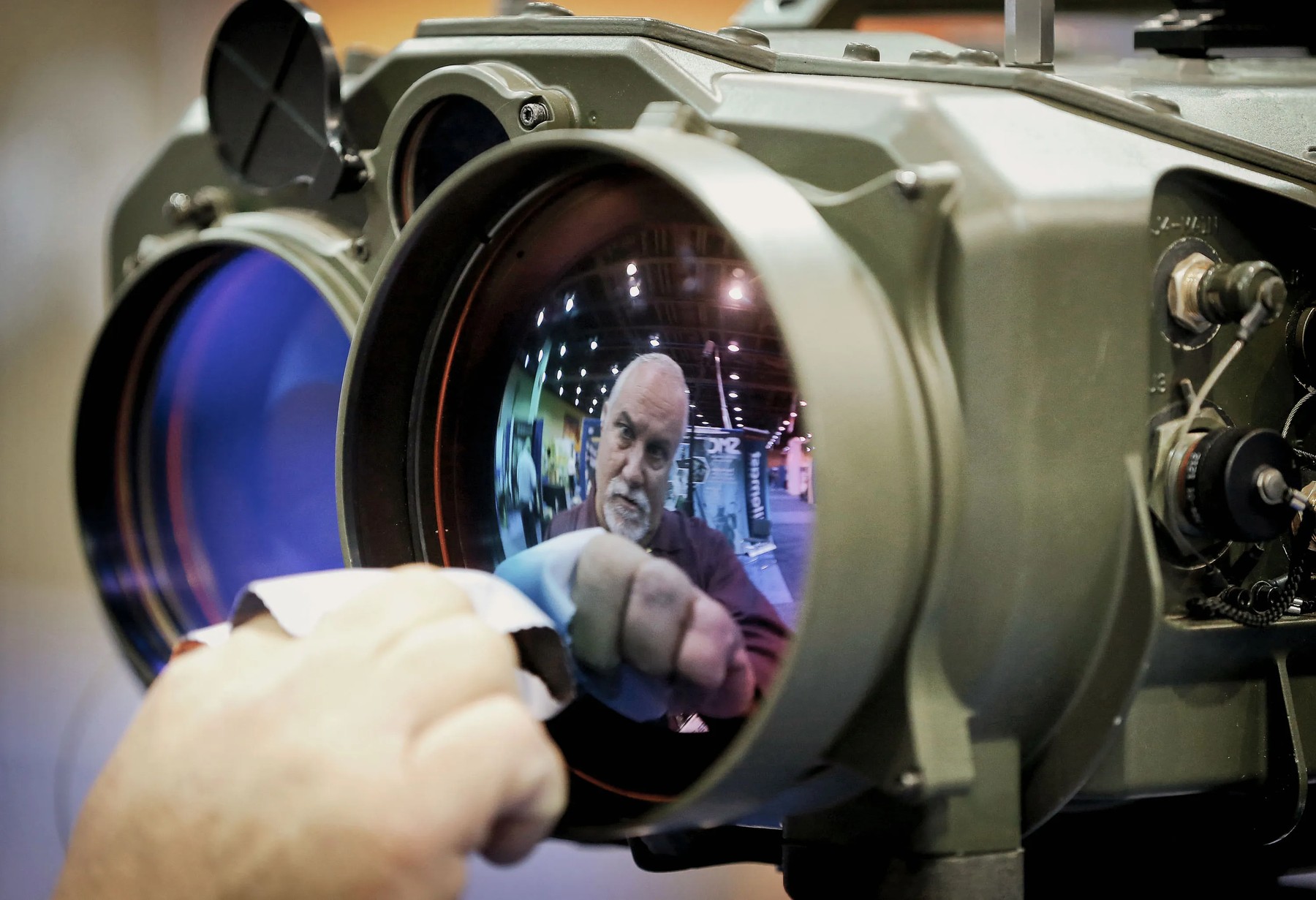 Gary Wagner of Elbit Systems of America cleans the lens of a long-range thermal imaging system at a 2014 border security expo.